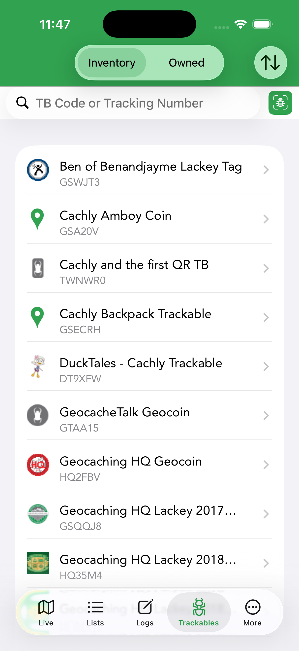 The Trackables tab — your inventory of Travel Bugs and geocoins (Inventory/Owned toggle, TB scanner).