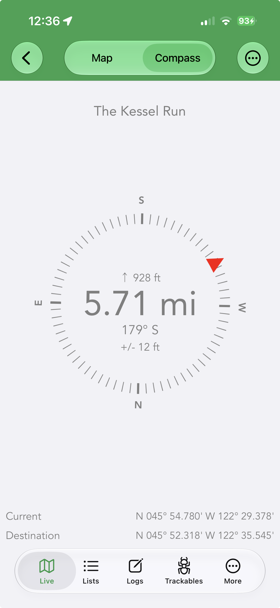 The Compass view of the Navigate screen: a red arrow points toward the cache, with distance, elevation, bearing and accuracy in the centre and current and destination coordinates at the bottom.