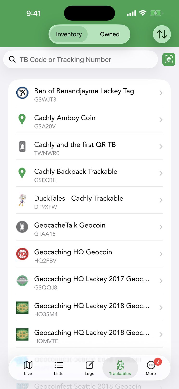 The Trackables tab — your inventory of Travel Bugs and geocoins, with the Inventory/Owned toggle, sort button, TB code search and scanner.